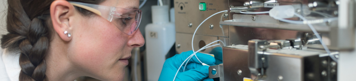 An analyst working with a piece of equipment in the lab.
